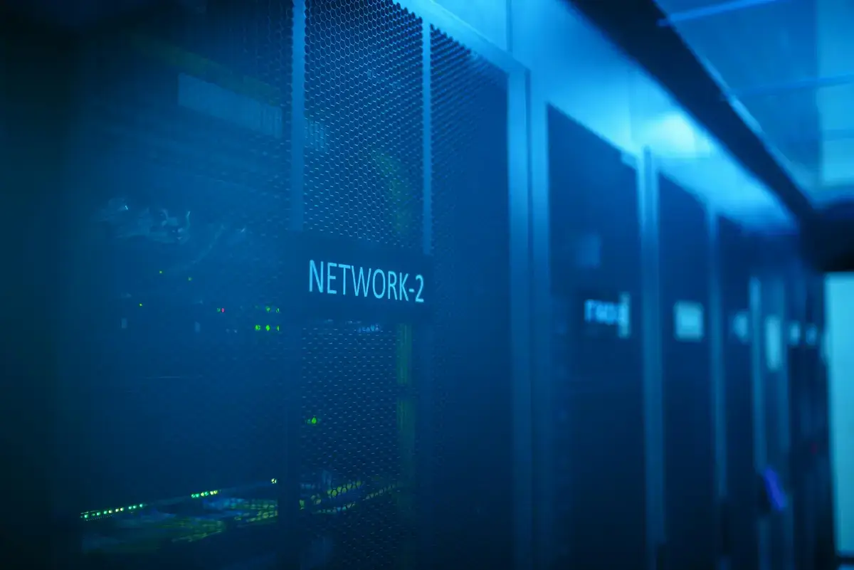 Modern datacenter interior showing server racks with LED lighting representing scale and technical sophistication of datacenter facilities